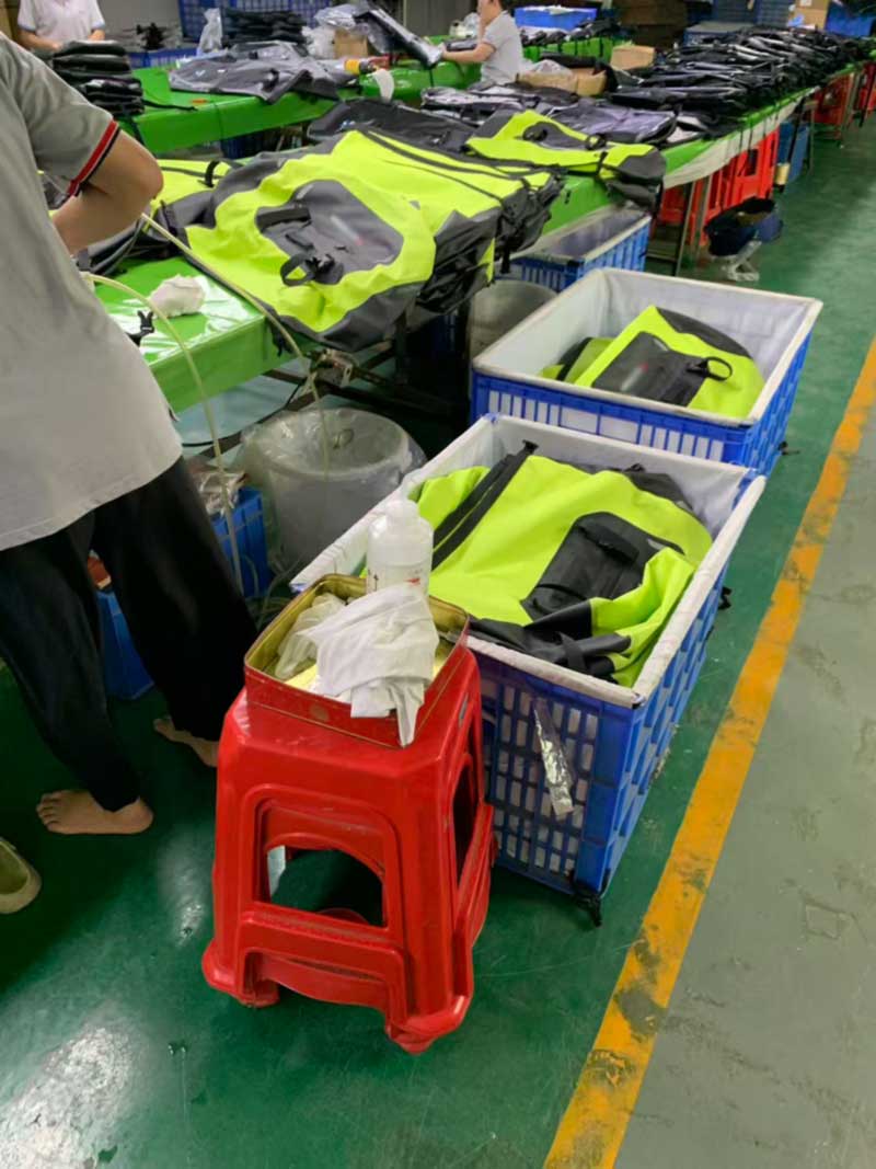 Leak test station with tested and untested bags separated into labelled crates